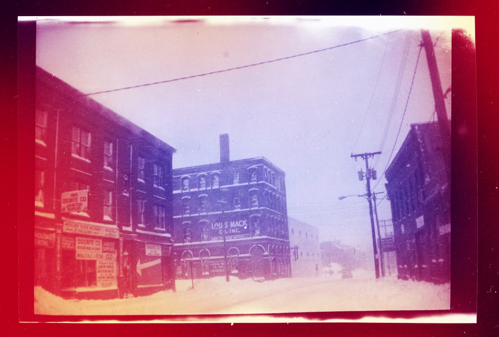 In a digitally colorized image suitable to the holiday season, here is Fore Street in Portland, Maine, early in 1982. The camera was a Kodak Brownie from the 1920s or '30s that I kept in the Squareback. I was on my way to work in the clip library at the Guy Gannett newspapers on a Saturday morning. Hubley Archives.