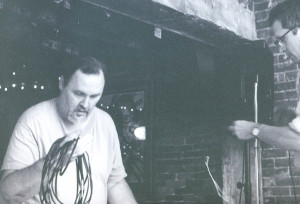 Alden Bodwell and Doug setting up the Turbines stage for a performance at the Free Street Taverna. Photo by Jeff Stanton.