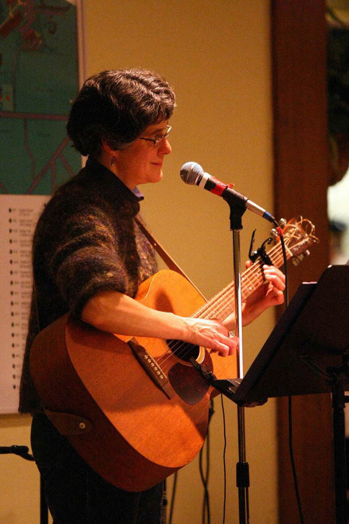 Gretchen Schaefer, smiling and strumming during one of Day for Night's first performances. The Bobcat Den, Bates College, Nov. 30, 2007. Photo by H. Lincoln Benedict.