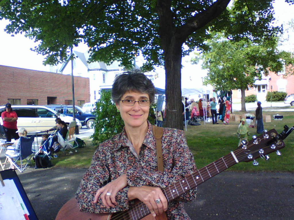 Gretchen Schaefer poses for a cell-phone picture during Day for Night's first performance, at the Lewiston (Maine) Farmers Market in July 2007. Hubley Archives